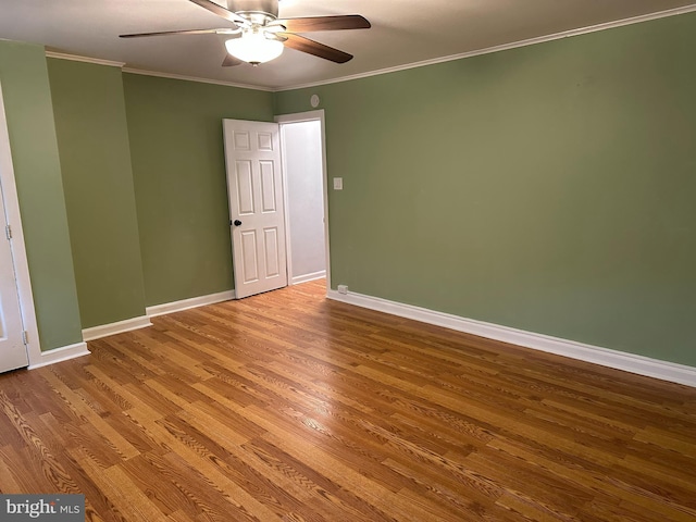 unfurnished room with hardwood / wood-style floors, ceiling fan, and crown molding