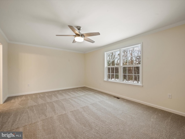 unfurnished room with crown molding, light colored carpet, and ceiling fan