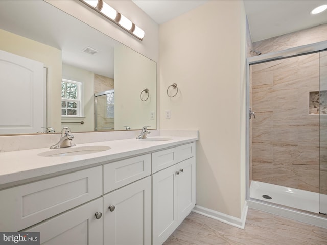 bathroom with vanity and a shower with shower door