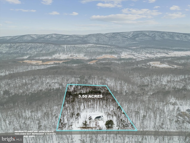 snowy aerial view featuring a mountain view