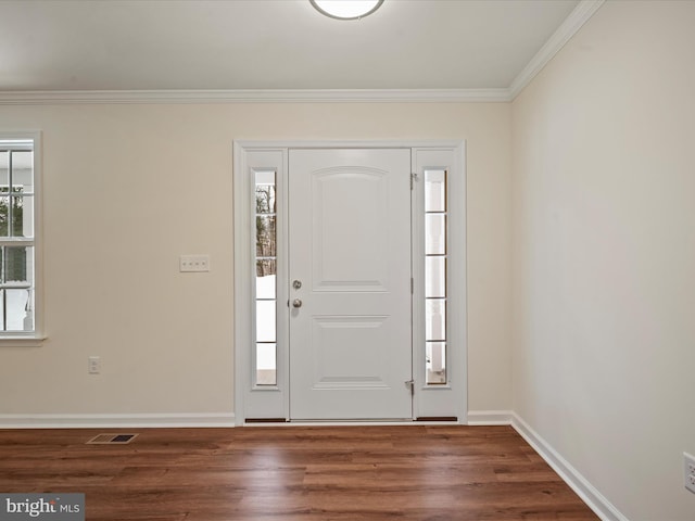 foyer featuring crown molding and dark hardwood / wood-style floors