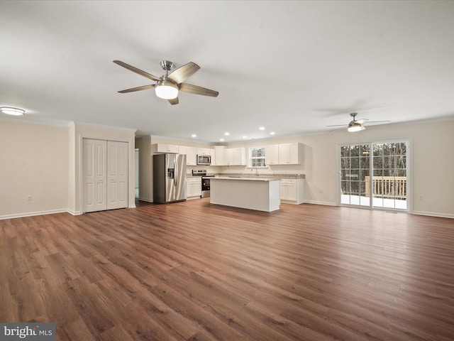 unfurnished living room with ceiling fan, ornamental molding, and dark hardwood / wood-style flooring