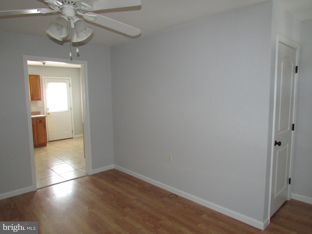 spare room featuring light wood-type flooring and ceiling fan