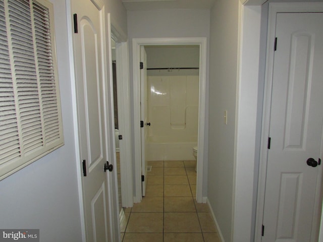 corridor with light tile patterned flooring