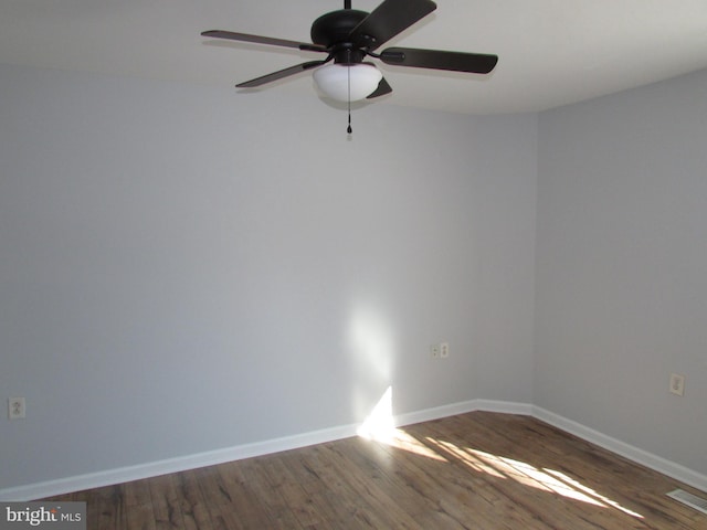 unfurnished room with ceiling fan and dark hardwood / wood-style flooring