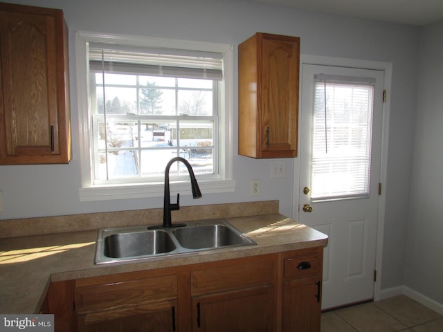 kitchen with sink and light tile patterned floors