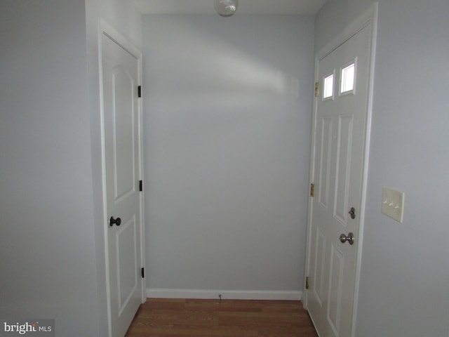 corridor with dark wood-type flooring