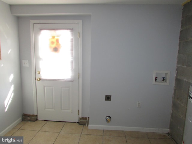 washroom featuring washer hookup, hookup for an electric dryer, and light tile patterned flooring