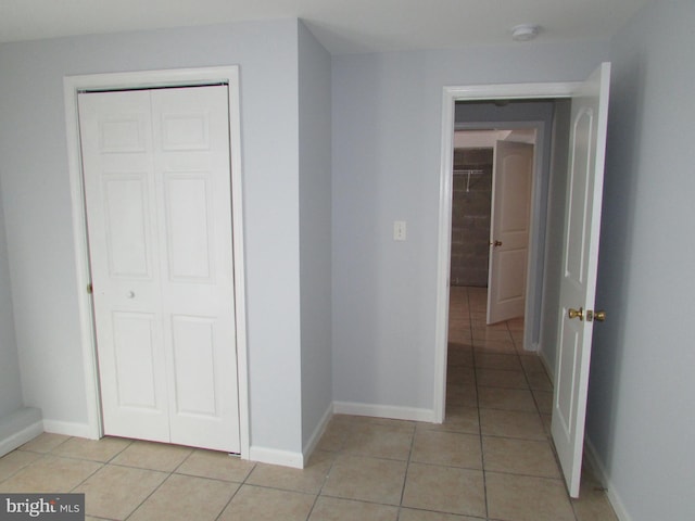 corridor with light tile patterned floors