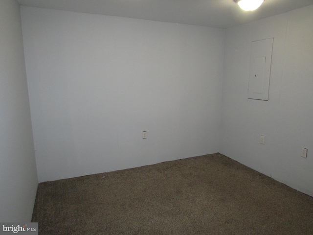 carpeted empty room with electric panel