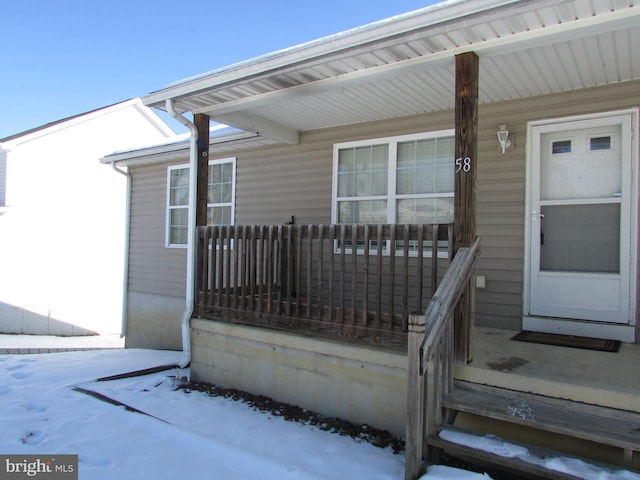 view of snow covered property entrance