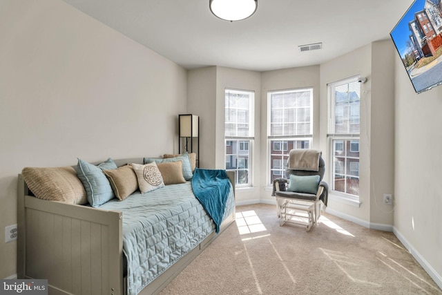 carpeted living room featuring visible vents and baseboards