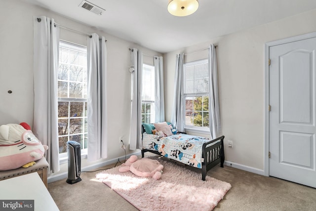 carpeted bedroom with baseboards and visible vents