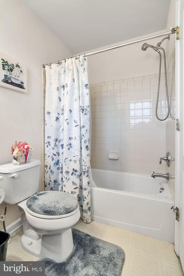 bathroom with shower / bath combination with curtain, toilet, and tile patterned floors