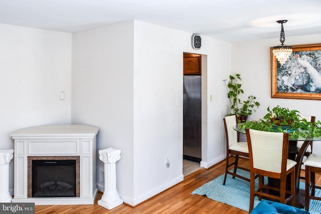 dining area with hardwood / wood-style floors and a chandelier