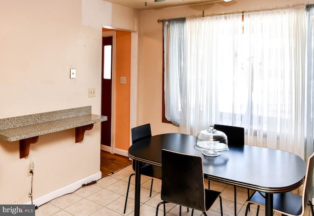 dining area featuring light tile patterned floors