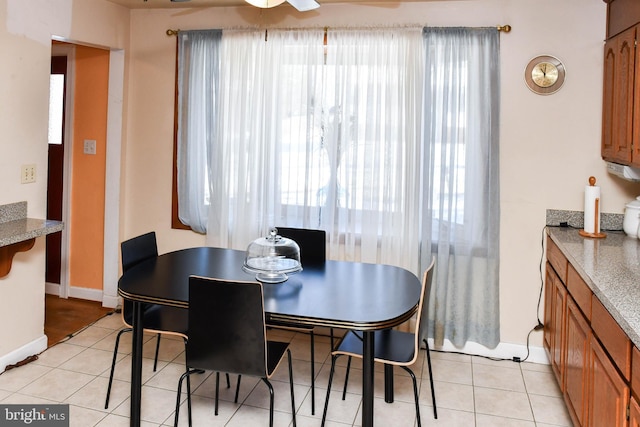 dining area with ceiling fan and light tile patterned flooring