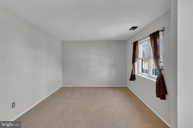 unfurnished room featuring light colored carpet