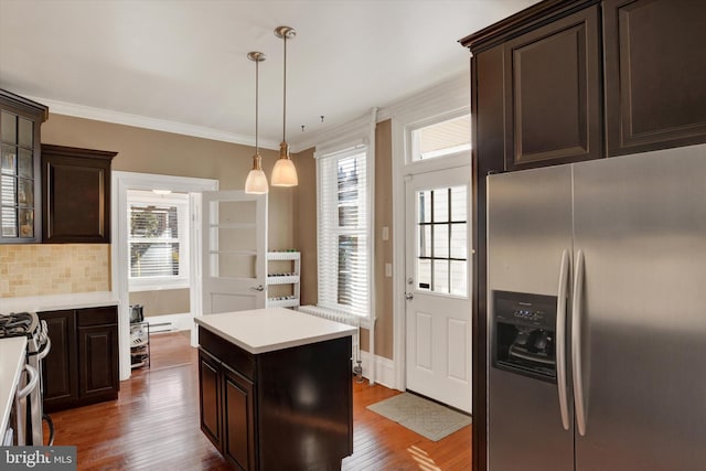 kitchen with stainless steel refrigerator with ice dispenser, backsplash, a center island, and a healthy amount of sunlight