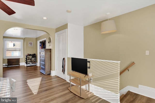 unfurnished living room with hardwood / wood-style floors and radiator