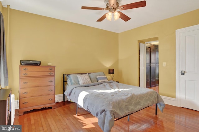 bedroom with ceiling fan and light hardwood / wood-style flooring