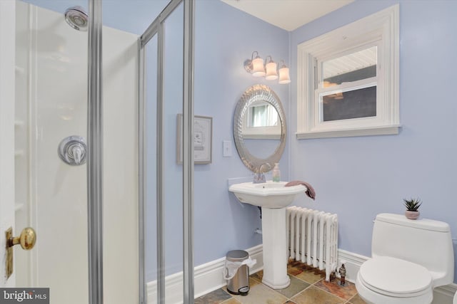 bathroom featuring toilet, an enclosed shower, and radiator