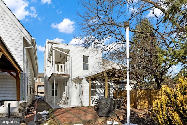 view of front of house with a balcony, a patio area, and a pergola