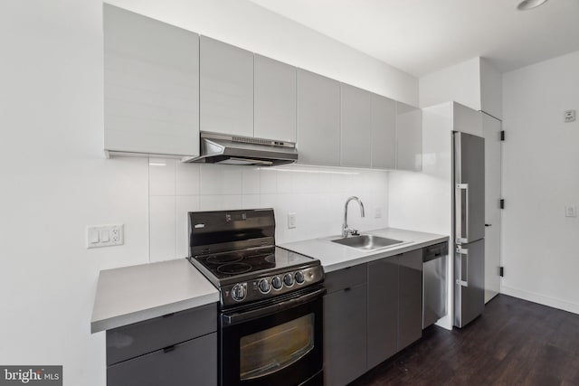 kitchen featuring appliances with stainless steel finishes, sink, gray cabinetry, and decorative backsplash