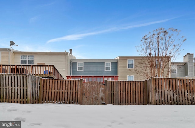 view of snow covered rear of property