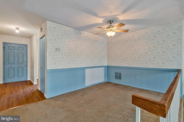 spare room featuring ceiling fan and carpet flooring