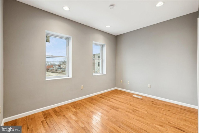 unfurnished room featuring light hardwood / wood-style floors