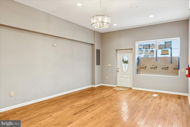 entryway featuring light hardwood / wood-style floors and an inviting chandelier