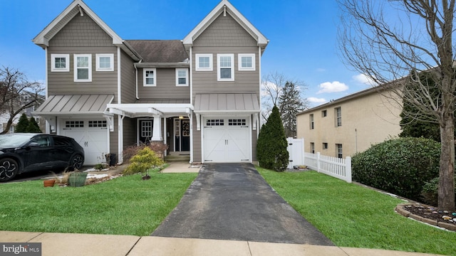 view of front of property featuring a front yard and a garage