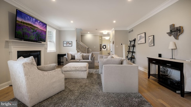 living room featuring wood-type flooring and ornamental molding