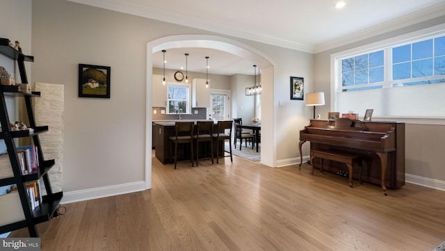 misc room featuring crown molding and light hardwood / wood-style flooring