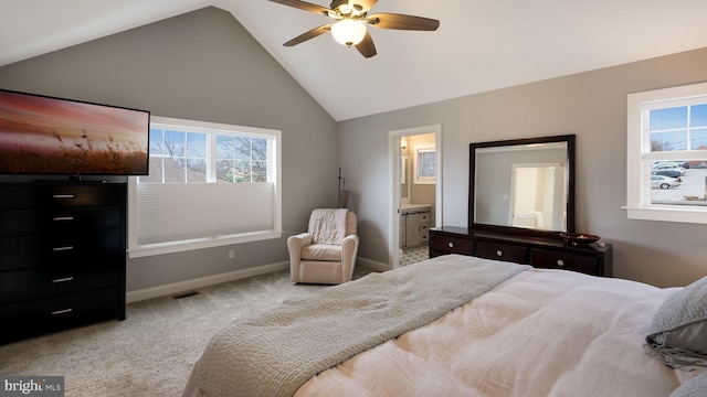 carpeted bedroom with ensuite bathroom, ceiling fan, and lofted ceiling