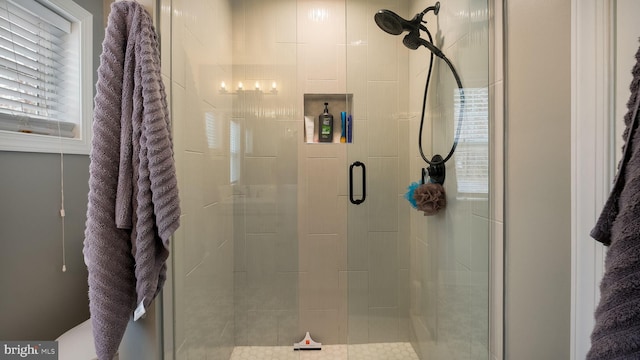 bathroom with a shower with shower door