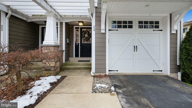 doorway to property featuring a garage