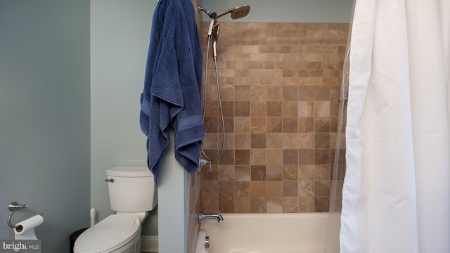 bathroom featuring toilet and shower / bath combo with shower curtain