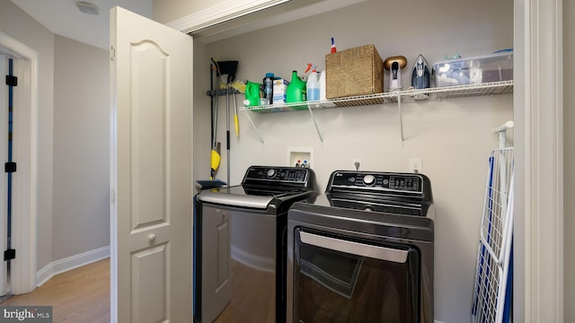 washroom featuring light hardwood / wood-style floors and washing machine and dryer