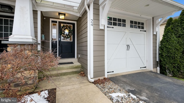 view of exterior entry with a garage