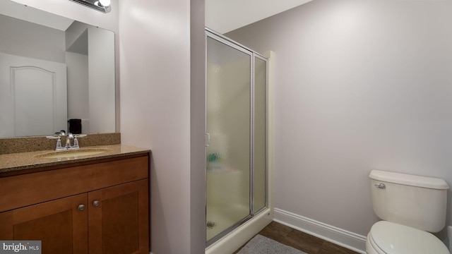 bathroom with vanity, an enclosed shower, and toilet