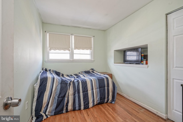 bedroom with hardwood / wood-style floors