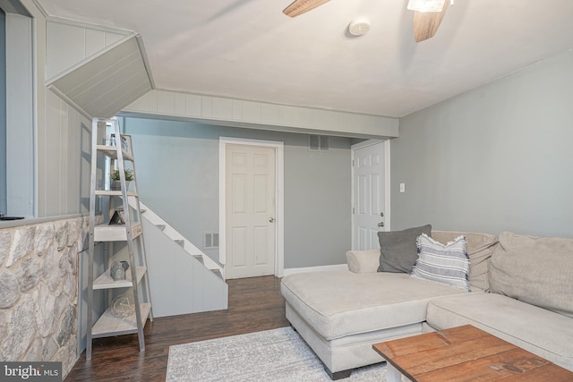 living room featuring ceiling fan and dark hardwood / wood-style flooring