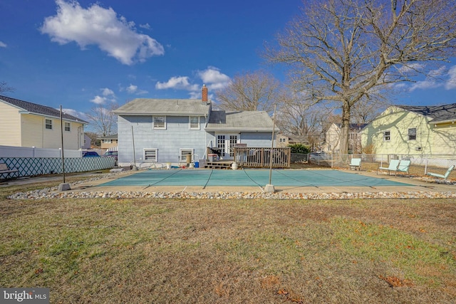 view of pool featuring a wooden deck, a patio, and a yard