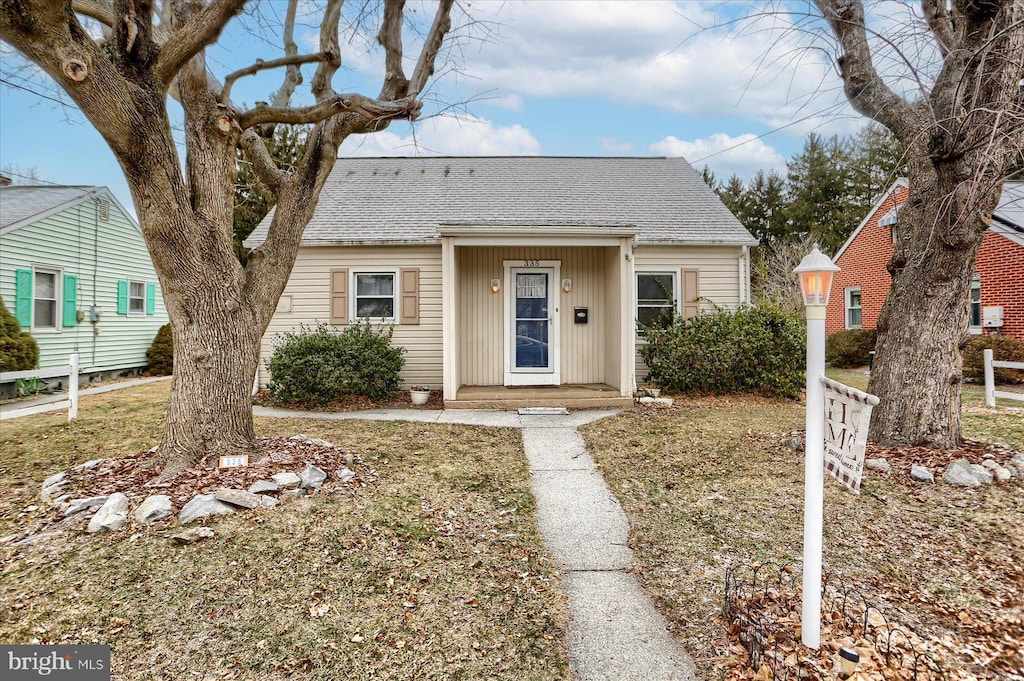 bungalow-style home with a front lawn