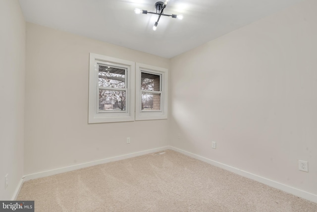 unfurnished room with light carpet