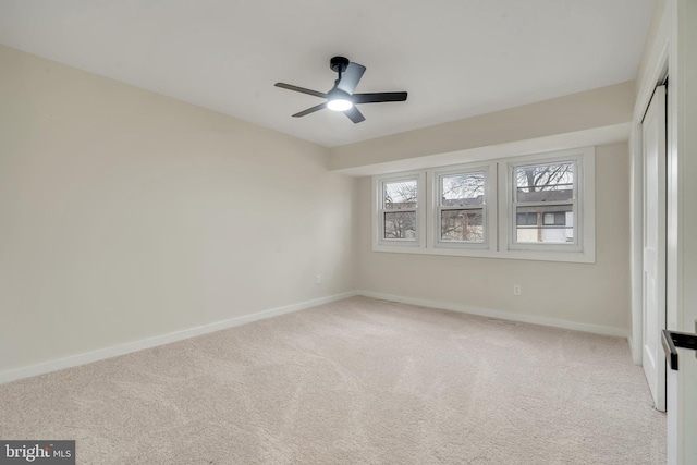 carpeted empty room featuring ceiling fan