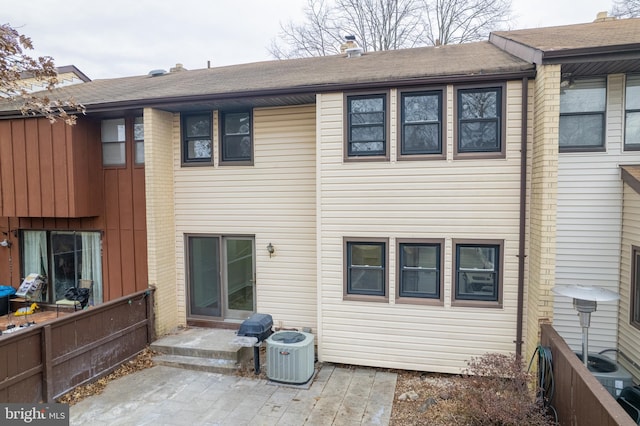 rear view of house with central AC