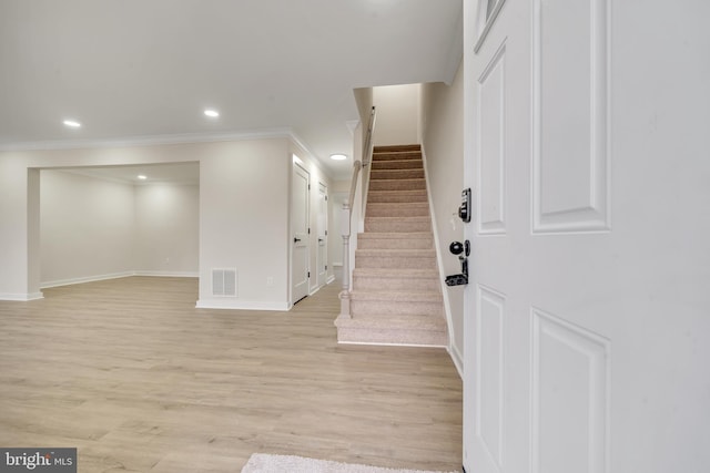 interior space with ornamental molding and wood-type flooring